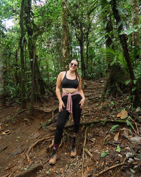 Woman on hike in jungle smiling