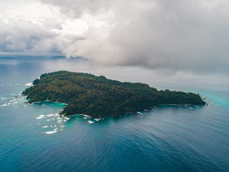 A small island in the middle of the ocean.