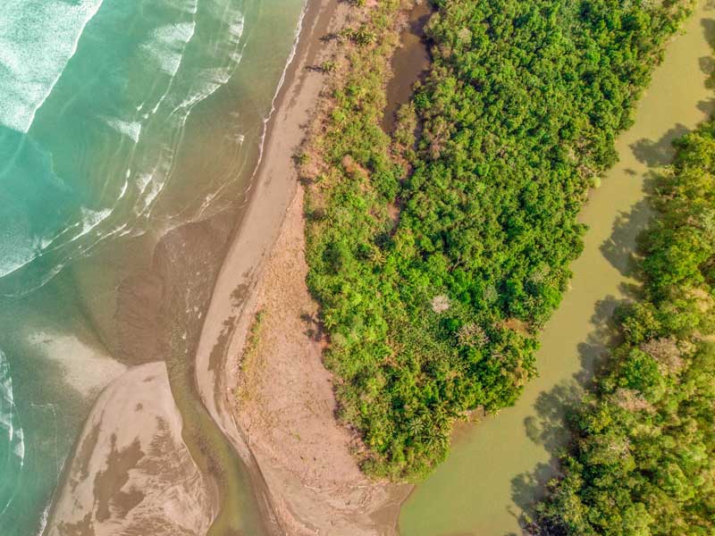 An aerial view of a beach and a body of water.