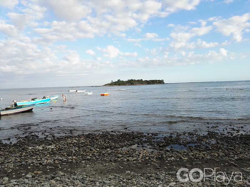 A group of boats floating on top of a body of water.