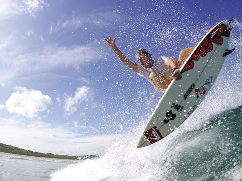 A man riding a wave on top of a surfboard.