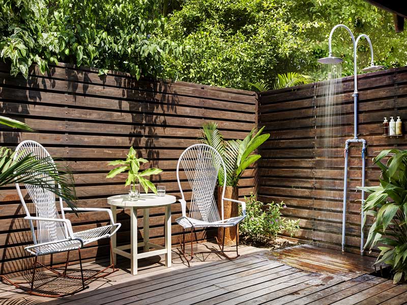 A wooden deck with two chairs and a table.