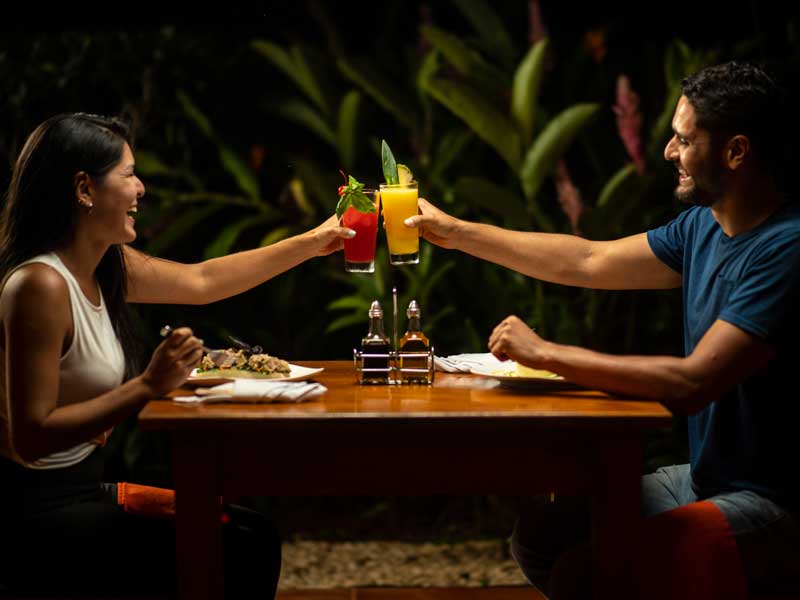 A man and a woman sitting at a table with drinks.