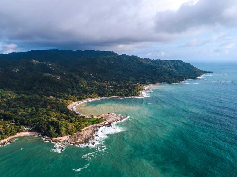 An aerial view of a beach and a forested area