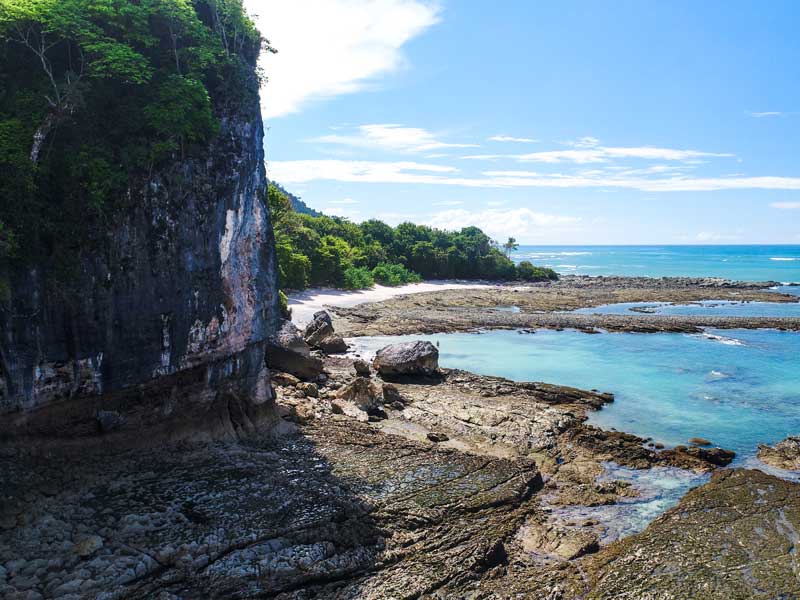 A view of a rocky beach with clear blue water